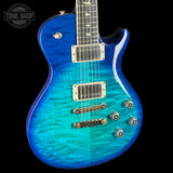 Blue electric guitar with a black background