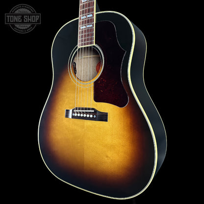 Acoustic guitar with a sunburst finish on a black background, featuring the Tone Shop logo.