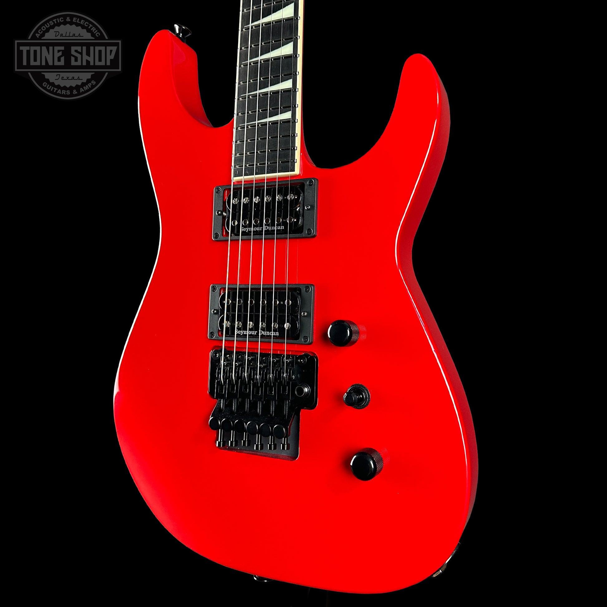 Red electric guitar on a black background with 'Tone Shop' logo.