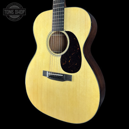 Acoustic guitar with a visible brand logo on a black background