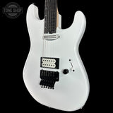 White electric guitar with a black pickguard on a black background, featuring 'Tone Shop' branding.