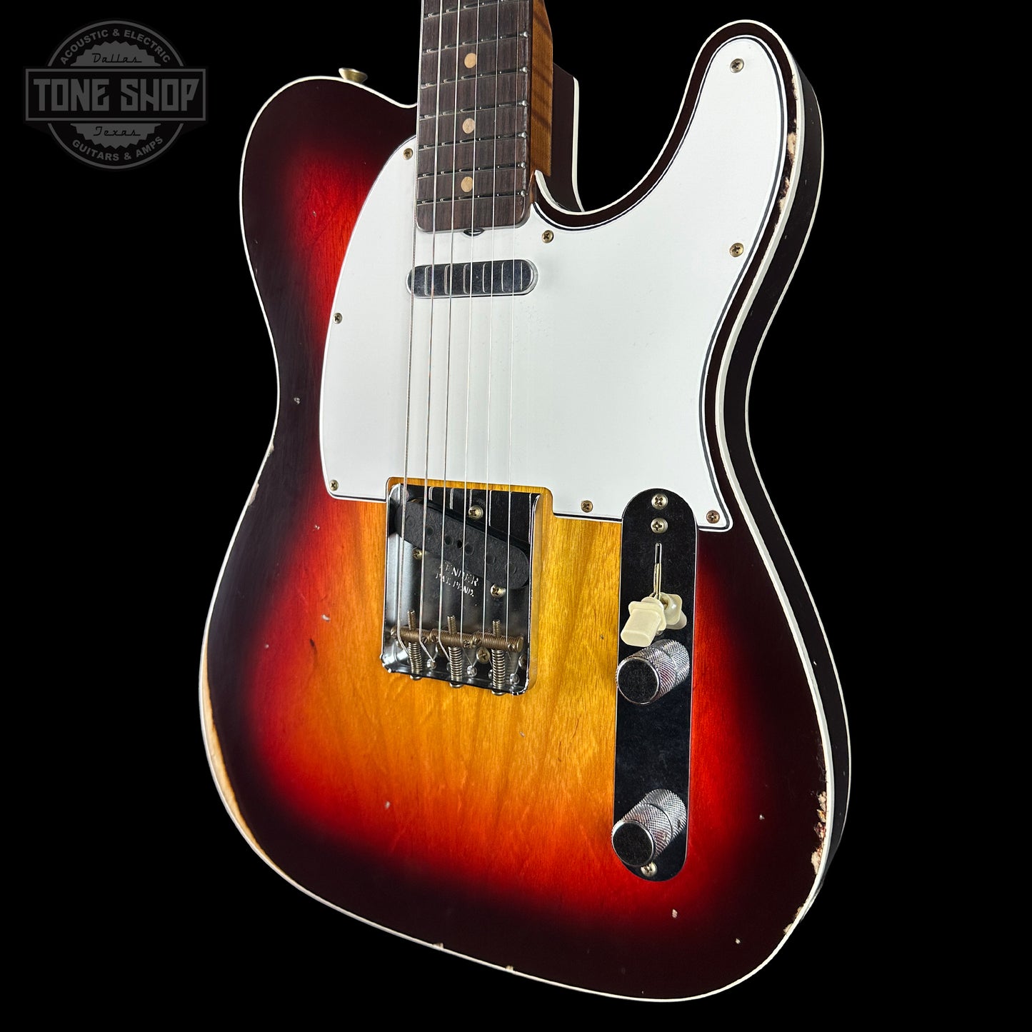 Electric guitar with a sunburst finish on a black background, featuring the Tone Shop logo.