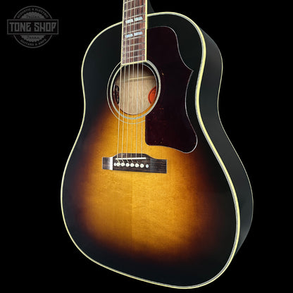 Acoustic guitar with a sunburst finish on a black background, featuring the Tone Shop logo.