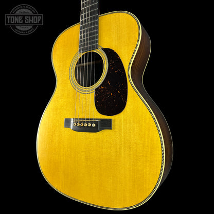 Acoustic guitar with a visible brand logo on a black background