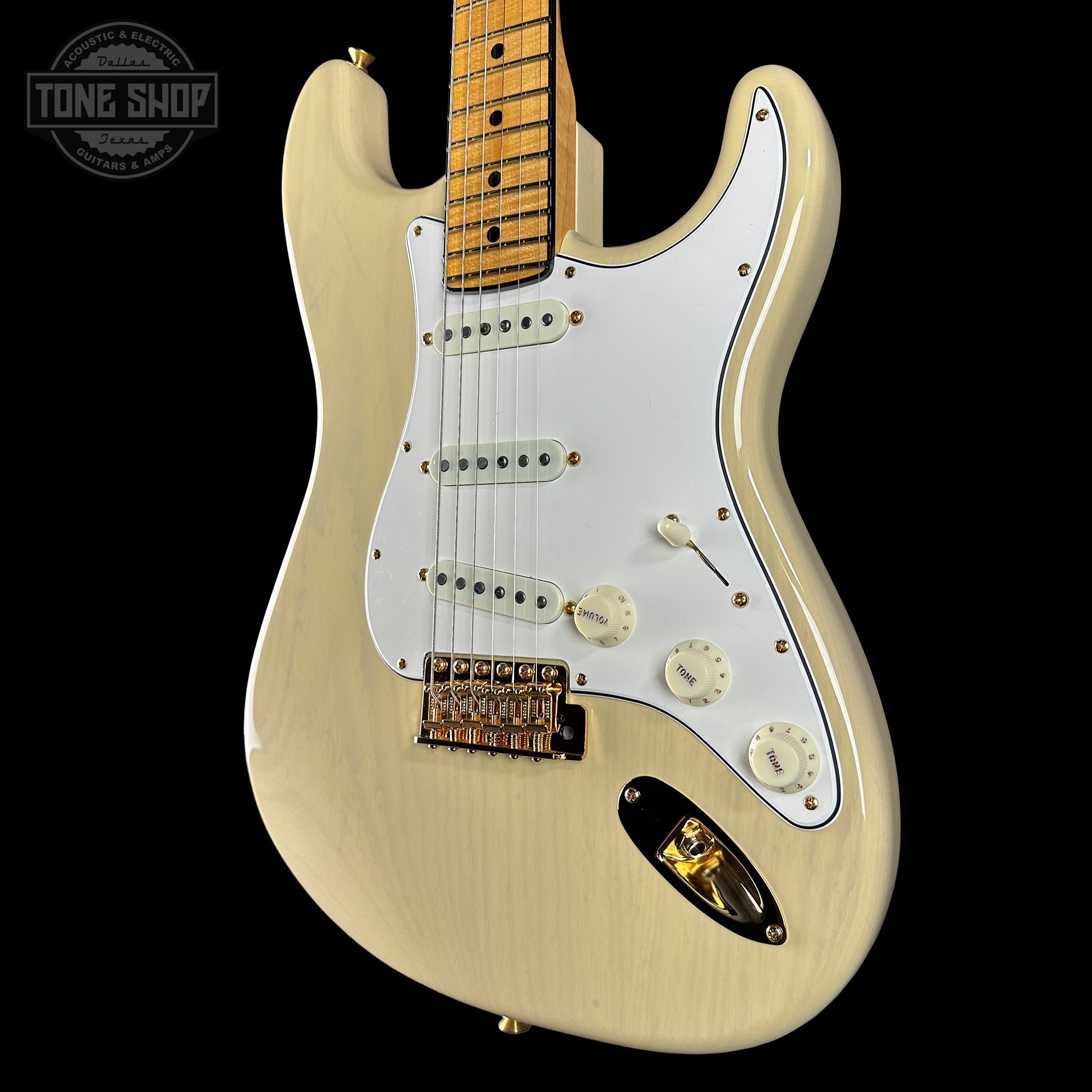 Beige electric guitar with a white pickguard on a black background, featuring 'Tone Shop' logo.