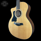 Acoustic guitar with a visible brand logo on a black background