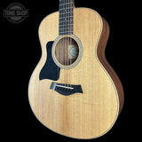 Acoustic guitar with a visible brand logo on a black background