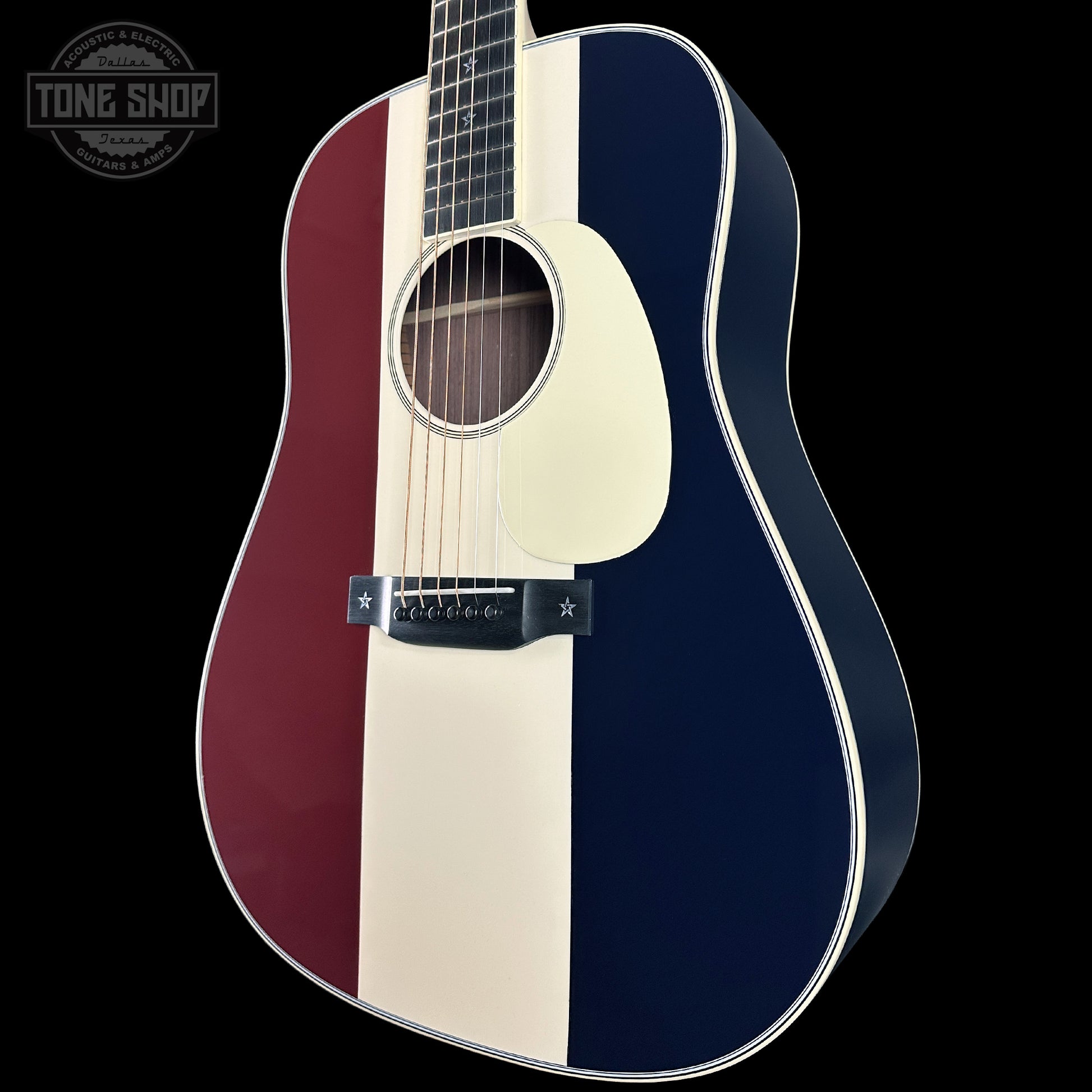 Acoustic guitar with a three-tone color pattern on a black background, featuring 'Tone Shop' branding.