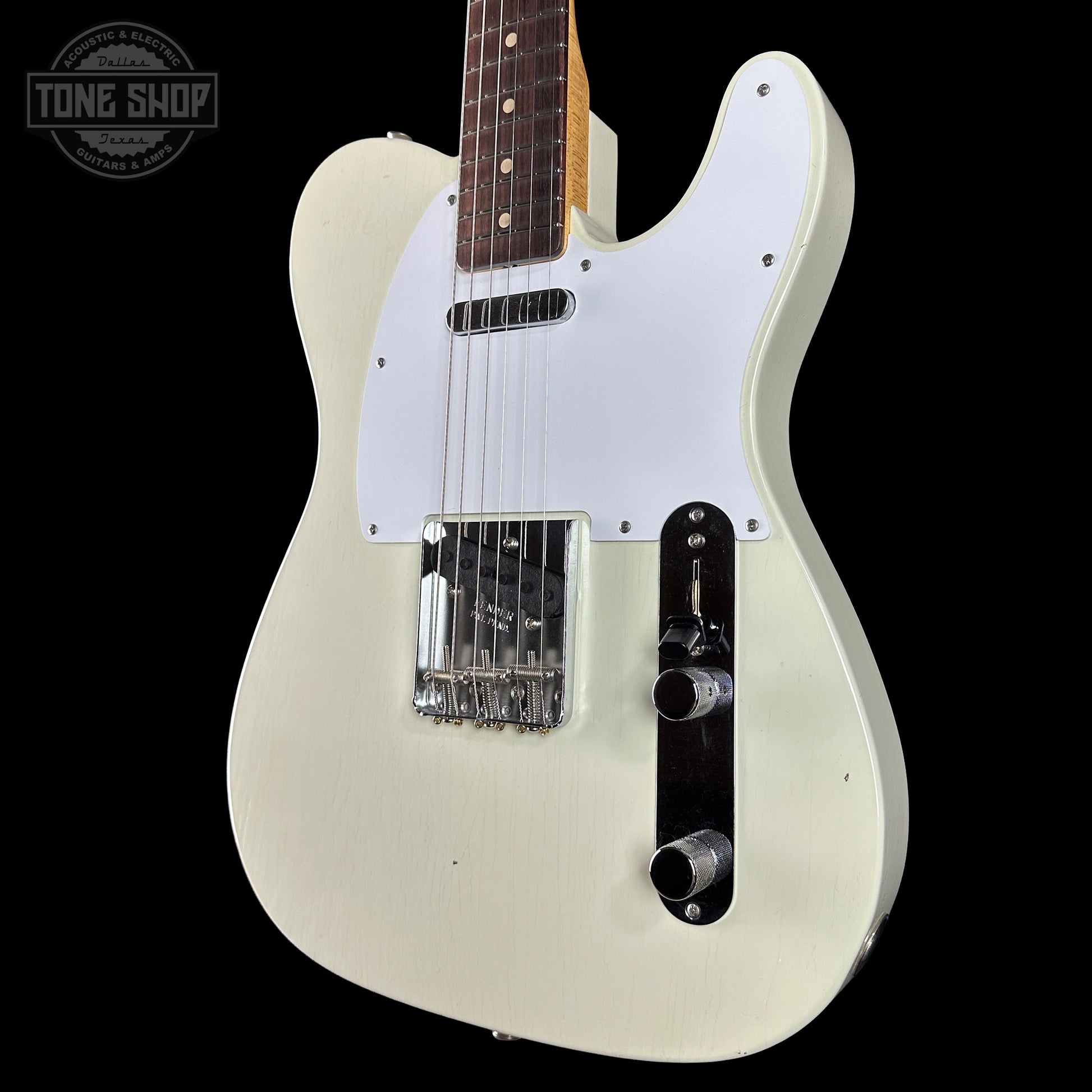 White electric guitar with a white pickguard on a black background, featuring 'Tone Shop' branding.