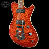 Electric guitar with a red, wavy wood finish on a black background