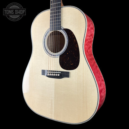 Acoustic guitar with a red binding on a black background, featuring the Tone Shop logo.