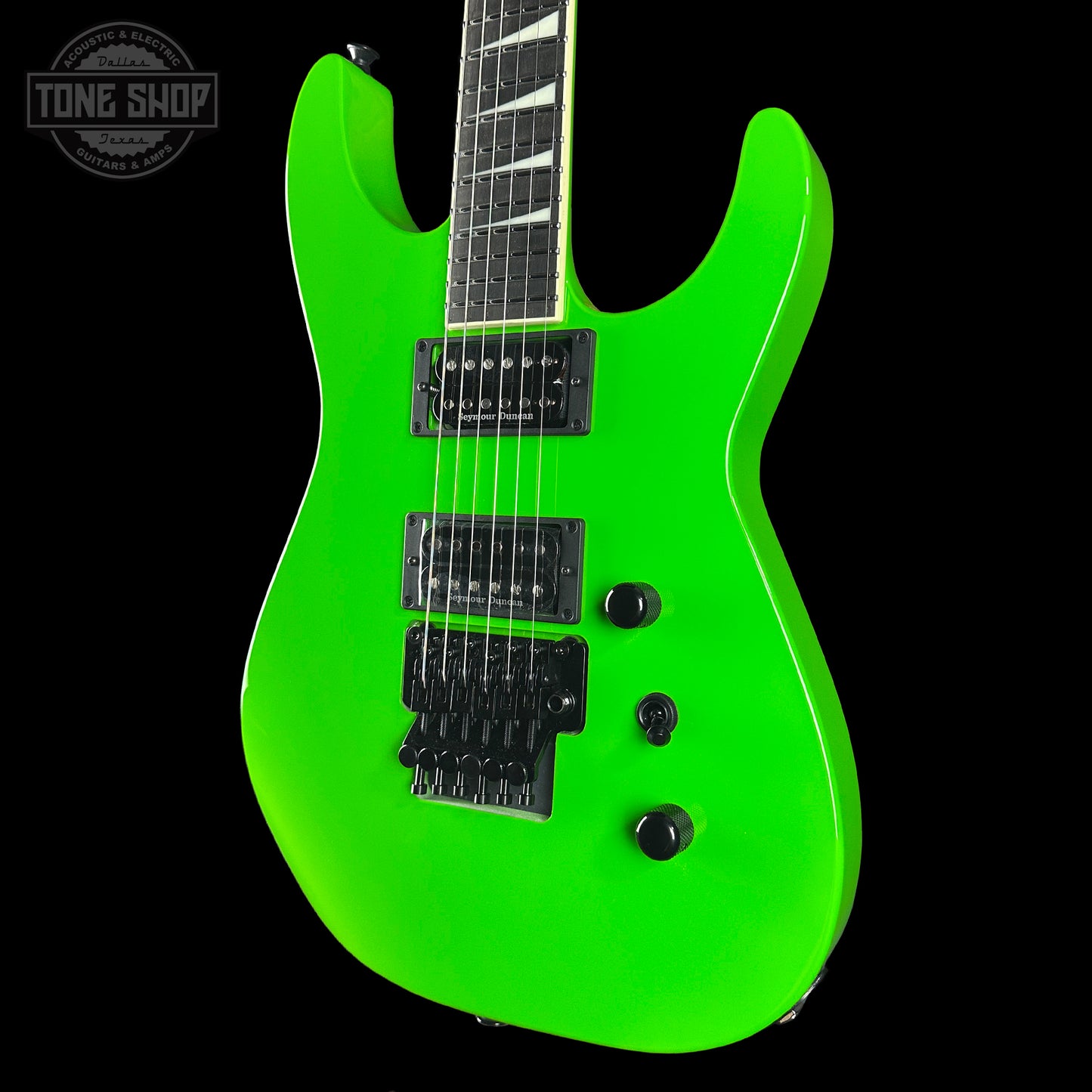 Green electric guitar on a black background with 'Tone Shop' logo.