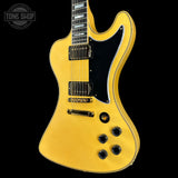Yellow electric guitar on a black background with 'Tone Shop' logo.