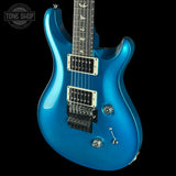 Blue electric guitar on a black background with 'Tone Shop' logo.