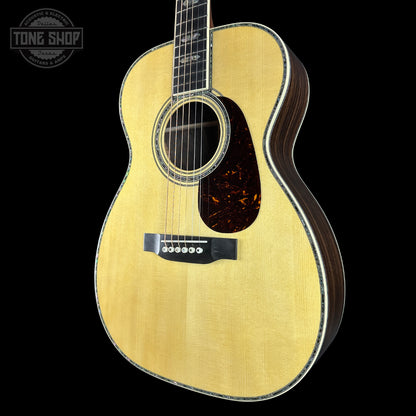 Acoustic guitar with a visible brand logo on a black background