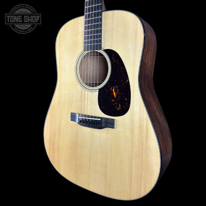 Acoustic guitar with a visible brand logo on a black background