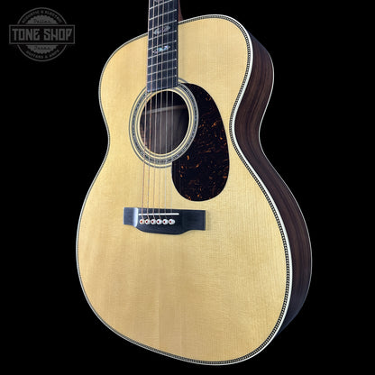 Acoustic guitar with a visible brand logo on a black background