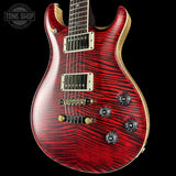 Red electric guitar with a black background, featuring the Tone Shop logo.