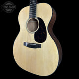 Acoustic guitar with a visible brand logo on a black background