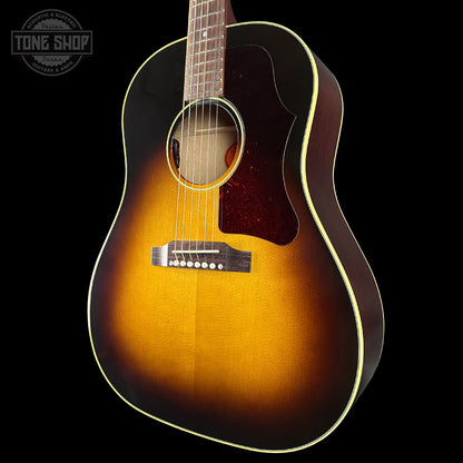 Acoustic guitar with a sunburst finish on a black background, featuring the Tone Shop logo.