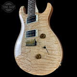 Front angle of PRS Wood Library Custom 24 Quilt 10 Top Natural.