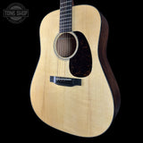 Acoustic guitar with a visible brand logo in the corner