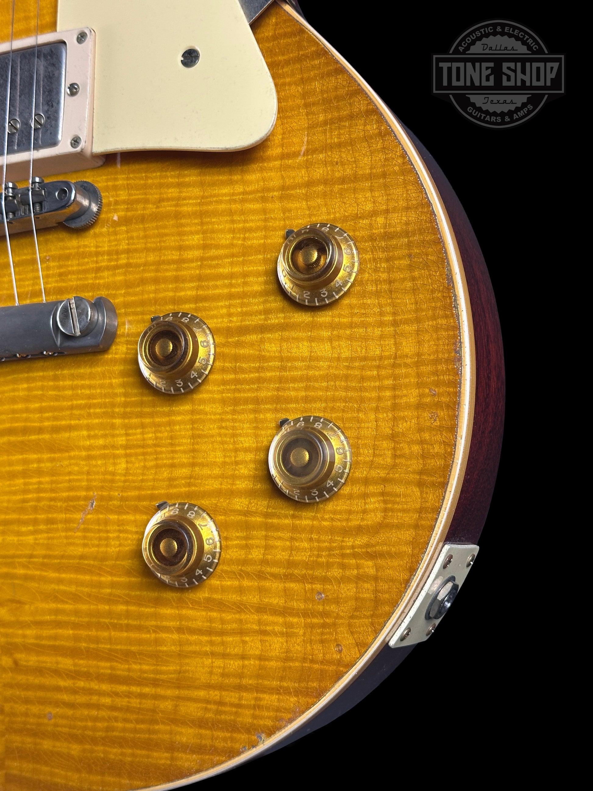 Close-up of a guitar with a visible brand logo in the corner.