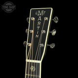 Martin guitar headstock with brand name on a black background