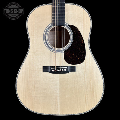 Acoustic guitar with a visible brand logo in the corner