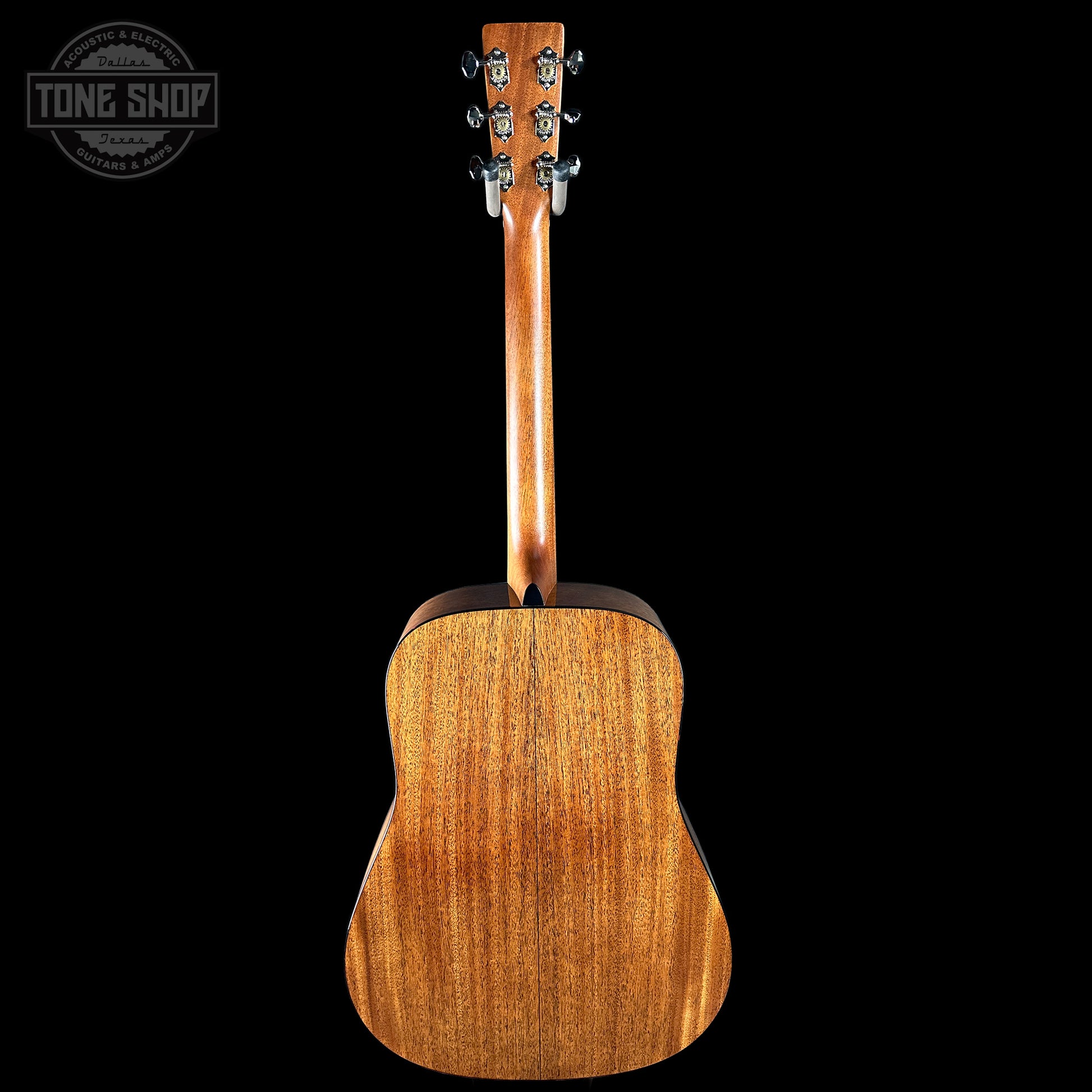 Back view of a wooden acoustic guitar on a black background with 'Tone Shop' logo.