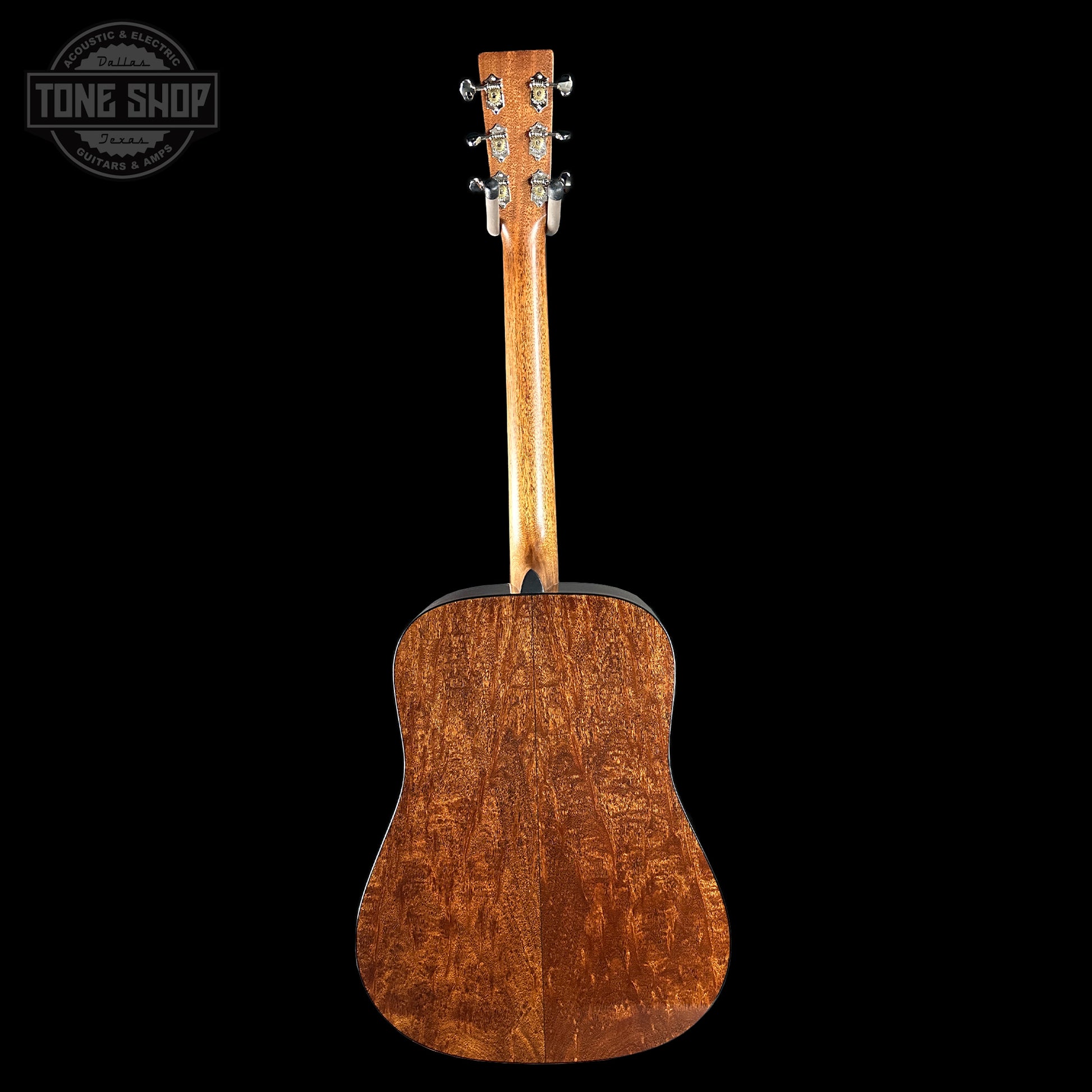Back view of a wooden acoustic guitar on a black background with 'Tone Shop' logo.