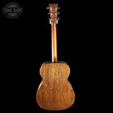 Back view of a wooden acoustic guitar with 'Tone Shop' logo in the corner.