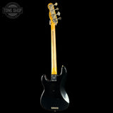 Black electric guitar with a visible brand logo on a white background