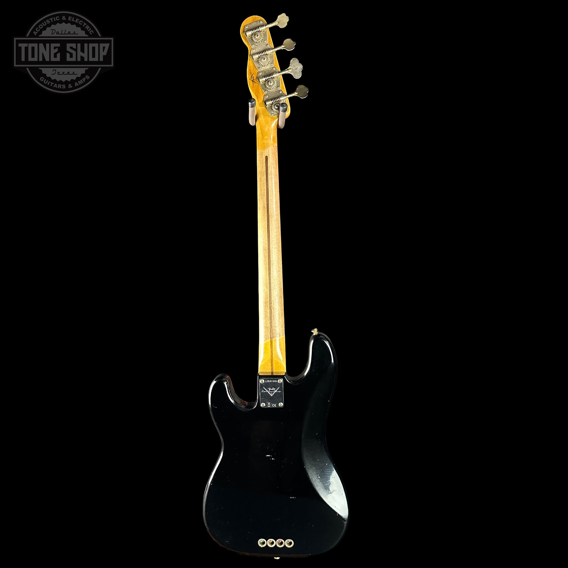 Black electric guitar with a visible brand logo on a white background