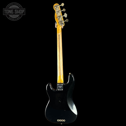 Black electric guitar with a visible brand logo on a white background
