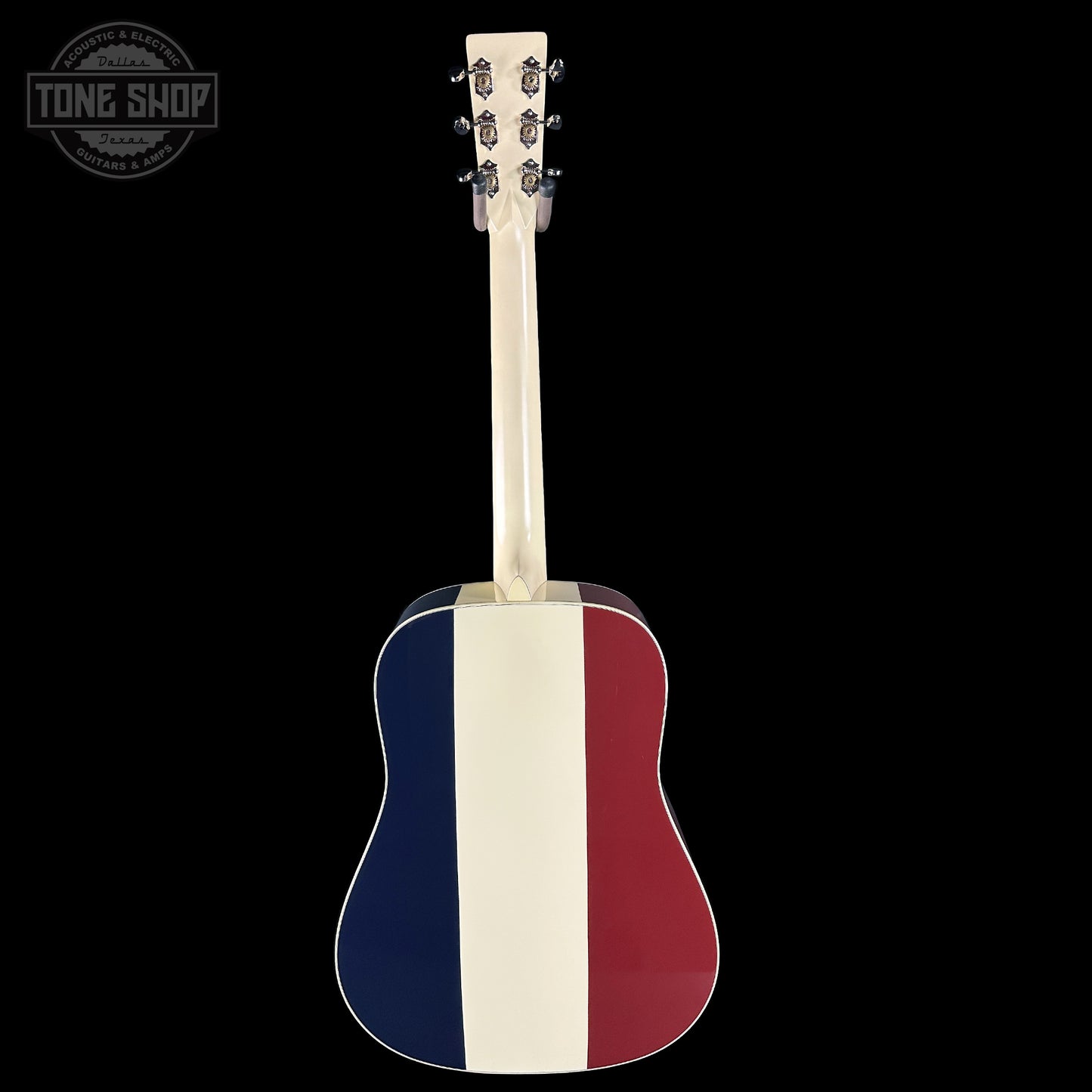 Acoustic guitar with a design resembling the French flag on a black background, featuring the Tone Shop logo.