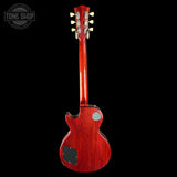 Red electric guitar on a black background with 'Tone Shop' logo.