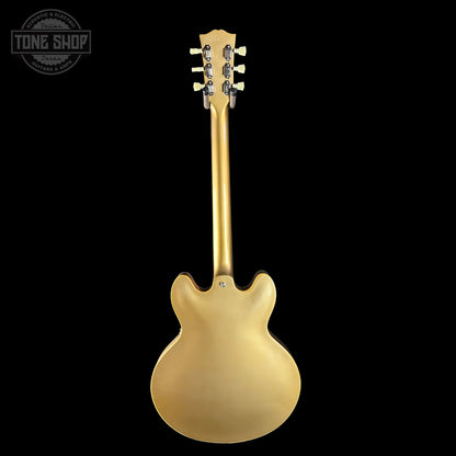 Gold electric guitar on a black background with 'Tone Shop' logo.