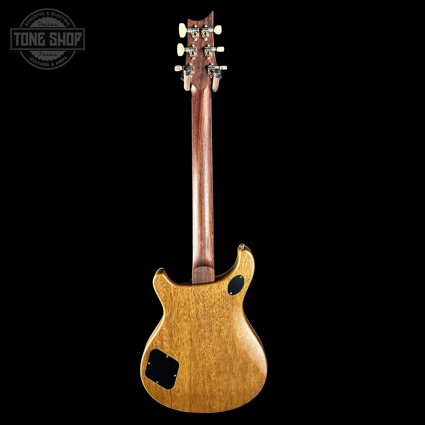Back view of a wooden electric guitar on a black background with 'Tone Shop' logo.