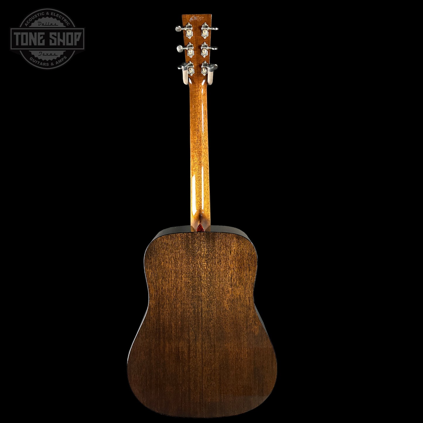 Back view of a wooden acoustic guitar with 'Tone Shop' logo.