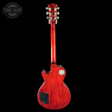 Red electric guitar on a black background with 'Tone Shop' logo.