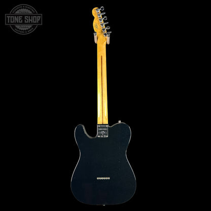 Black electric guitar with a blonde neck on a white background, featuring the Tone Shop logo.