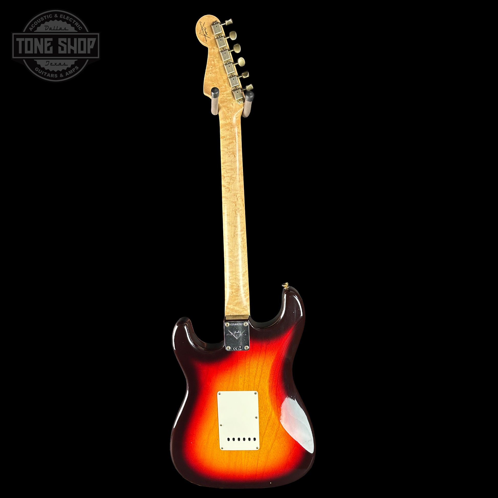 Electric guitar with a sunburst finish on a black background, featuring the Tone Shop logo.