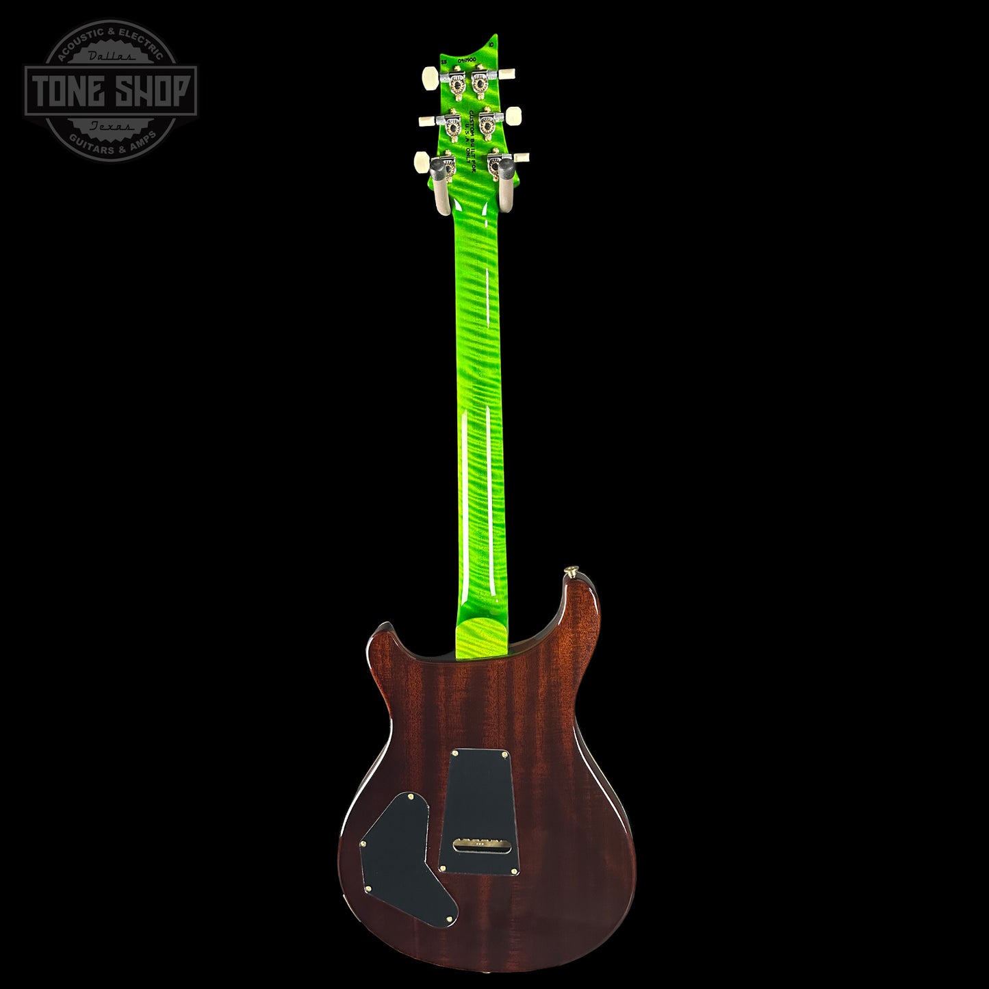 Electric guitar with a green pickguard on a black background, featuring the Tone Shop logo.