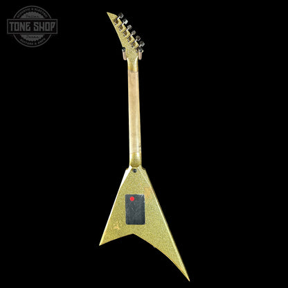 Gold electric guitar with a black background