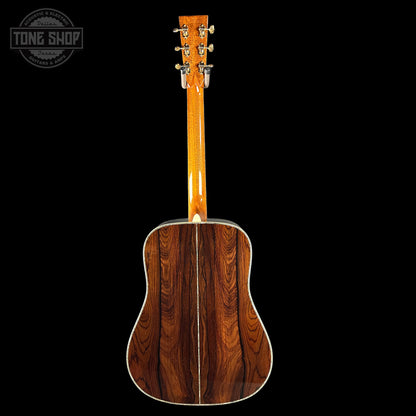 Acoustic guitar with a wooden finish on a black background, featuring the Tone Shop logo.