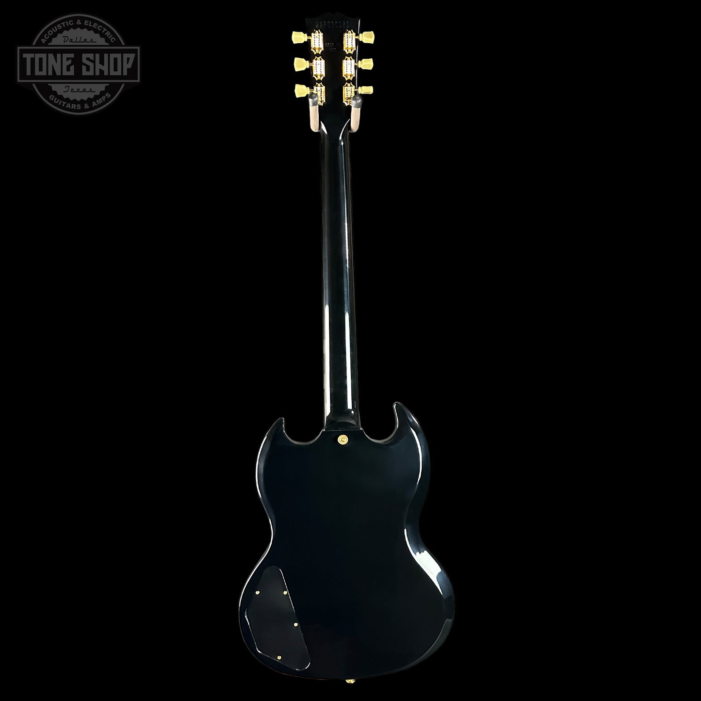 Black electric guitar with a 'Tone Shop' logo in the corner