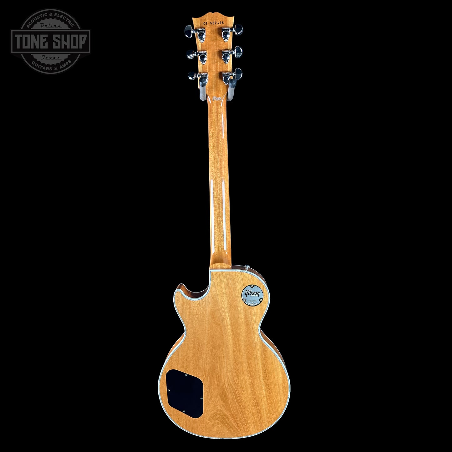 Wooden electric guitar with a clear finish on a black background, featuring the Tone Shop logo.