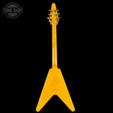 Yellow electric guitar with a black background