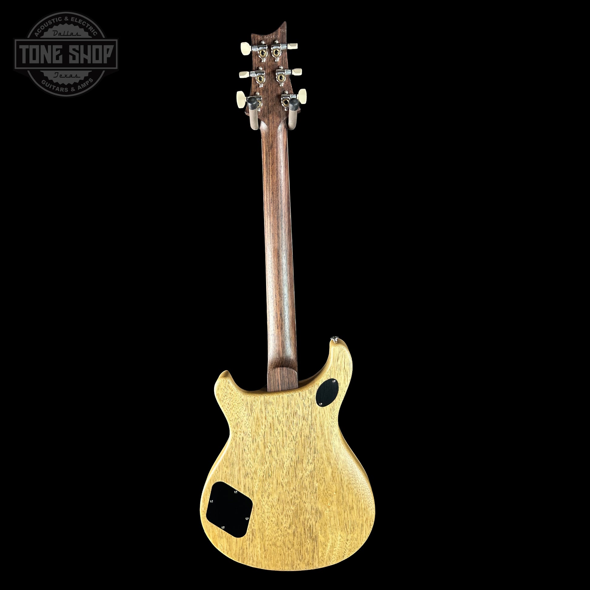 Back view of a guitar with a visible brand logo in the corner.